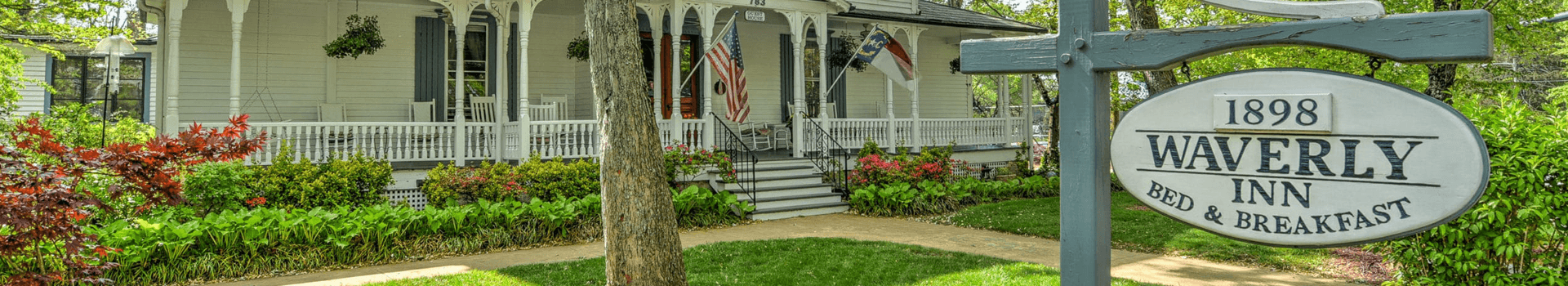 A historic bed and breakfast, Waverly Inn, featuring a welcoming porch and lush gardens.