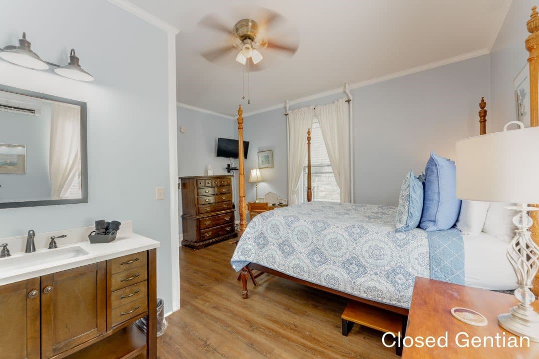 Closed Gentain Room featuring a large in-room vanity. A tall dresser and desk with chair are in the corner.